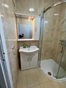 a bathroom with a sink and a shower at Glebe Street Dumfries in Dumfries