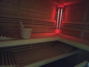 a red light in a room with a bucket at Secret Paradise in Ronsberg