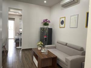 a living room with a couch and a table at DK APARTMENT in Hai Phong