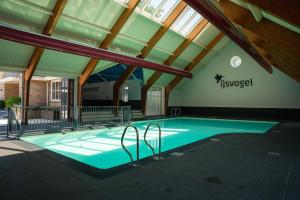 a swimming pool in the middle of a building at Chalet de Elina - comfortable chalet for a relaxing stay in Voorthuizen