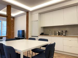 a kitchen with a white table and chairs at Fomento by Wynwood House in Madrid