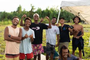 a group of young men posing for a picture at Medewi Secret SurfCamp in Pulukan