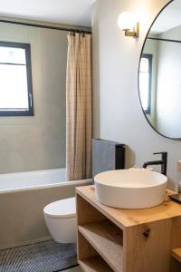 a bathroom with a sink and a toilet and a mirror at Abitaziun Patgific in Trin