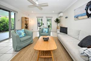 a living room with a couch and two chairs and a table at Golden Beach Family Relaxation in Golden Beach