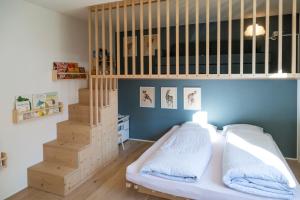 a small bedroom with a bunk bed and a staircase at Abitaziun Patgific in Trin