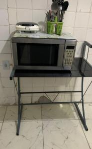 a microwave sitting on a table in a kitchen at Hostel Brasil Recife in Recife