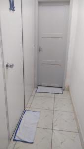 a small room with a door and a tile floor at Hostel Brasil Recife in Recife