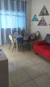 a living room with a table and chairs and a couch at Hostel Brasil Recife in Recife