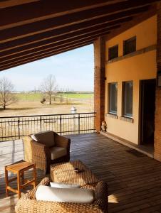 a patio with a couch and a table on a deck at Private Room in the Food Valley of Parma in Montechiarugolo