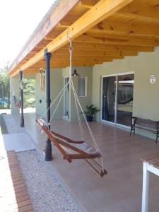 a porch with a hammock hanging from a roof at El Destino in San Miguel del Monte