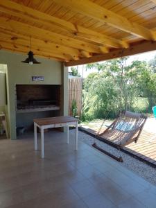 a porch with a swing and a hammock at El Destino in San Miguel del Monte