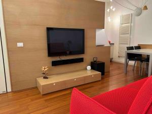 a living room with a flat screen tv on a wall at Mimi’ House in Cantù
