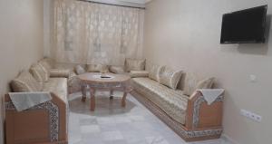 a living room with a couch and a table at RELAX IBN BATOUTA in Tangier