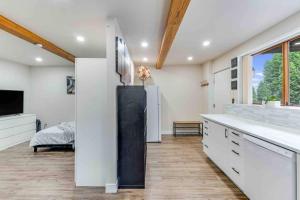 a kitchen with white walls and a large counter top at Adorable new studio with free parking and WiFi in Federal Way