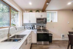 a kitchen with a sink and a microwave at Adorable new studio with free parking and WiFi in Federal Way