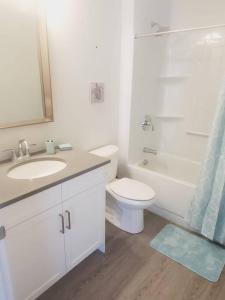 uma casa de banho branca com um WC e um lavatório em Adorable Cottage Port Stanley em Port Stanley