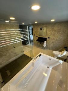 a large bathroom with a tub and a toilet at Hotel Joy Cll 85 in Bogotá