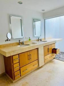 ein Badezimmer mit 2 Waschbecken und einem Spiegel in der Unterkunft CASA MERO de lujo vacacional in La Paz