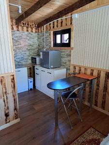 uma pequena cozinha com uma mesa num quarto em Hostal Robinson em Puyuhuapi