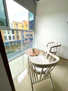 カリにあるBRR LIMONAR - Nuevo, Cómodo y hermoso aparta estudio 301の窓のある客室で、椅子2脚とテーブル1台が備わります。