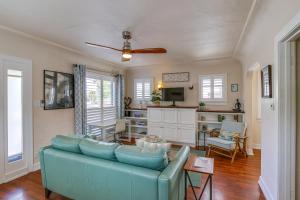 a living room with a blue couch and a tv at Charming Bungalow Near LA Waterfront and Beaches in San Pedro