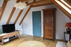 Habitación con puerta azul y mesa de madera. en Rudelle maison de vacances en Rudelle