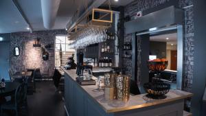 a bar in a restaurant with a brick wall at Hotell Boras, BW Signature Collection in Borås
