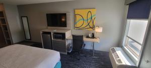 多思威勒的住宿－道明國王戴斯酒店，酒店客房配有一张床和一张书桌及一台电视