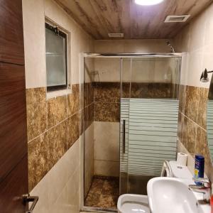 a bathroom with a glass shower and a sink at Quadro apartment in Amman +9 photos