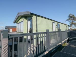 a mobile home with a porch and a railing at Walkers Rest in Ganton