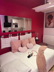 a bedroom with a large bed with red walls at Honey Room22 , parking, proche gare in Saint-Brieuc