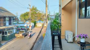 a young girl riding a bike down a city street at Captain Joe Cafe & Hostel in Hua Hin