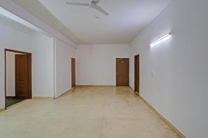 an empty room with white walls and a ceiling at OYO Omi Guest House in Gurgaon