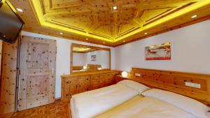 a bedroom with a bed and a yellow ceiling at Paravicini 1 in St. Moritz