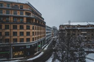 a snow covered city with a building and buildings at Modern Charm Stylish Studio in Sodermalm in Stockholm