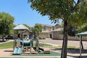 a playground with a slide in a park at NEW - 5BR Home 20 min from Phoenix - AT in Avondale