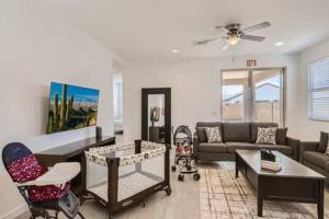 a living room with a couch and a table at NEW - 5BR Home 20 min from Phoenix - AT in Avondale