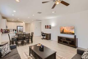 a living room with a couch and a dining room at NEW - 5BR Home 20 min from Phoenix - AT in Avondale