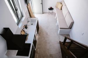 a bathroom with a couch and a sink in a room at 1919's Studio in Asklipiḯon +4 photos