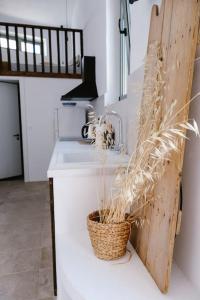 a kitchen with a sink and a basket of wheat at 1919's Studio in Asklipiḯon