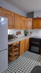 a kitchen with wooden cabinets and a checkered floor at Apt close to Temple Bar in Dublin