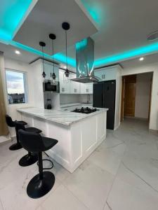 een keuken met een wit aanrecht en zwarte apparaten bij Apartamento en Playa Palenque in Puerto Palenque