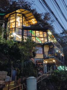 a house on top of a hill at night at Holyghost Veranda Baguio Transient Guest House 42 step rooftop in Baguio +15 photos