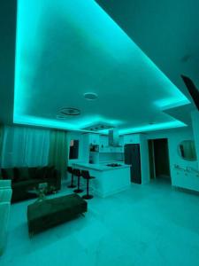 a living room with blue lights on the ceiling at Apartamento en Playa Palenque in Puerto Palenque