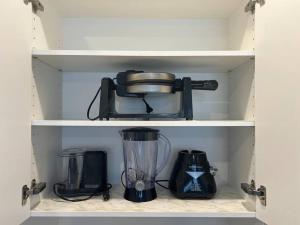 a cupboard with a blender and other kitchen items at Your Cozy Retreat, 2BR suite in Kamloops
