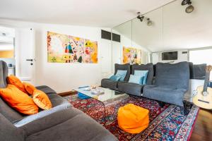 a living room with two couches and a rug at Penthouse Le Terrazze Duomo view in Florence