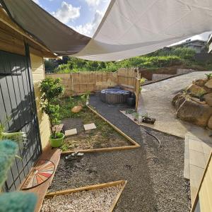 a backyard with a tent and a garden with a fire pit at La PersévéranS avec SPA in Le Lamentin