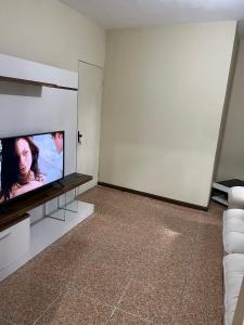 a living room with a flat screen tv on a wall at Apartamento Boa Vista in Garanhuns
