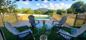 a patio with chairs and a table and a pool at PARAISOS DE GABRIELA in Villalba