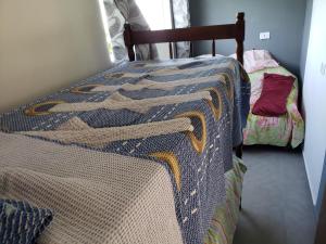 A bed or beds in a room at Residencial Mineiro